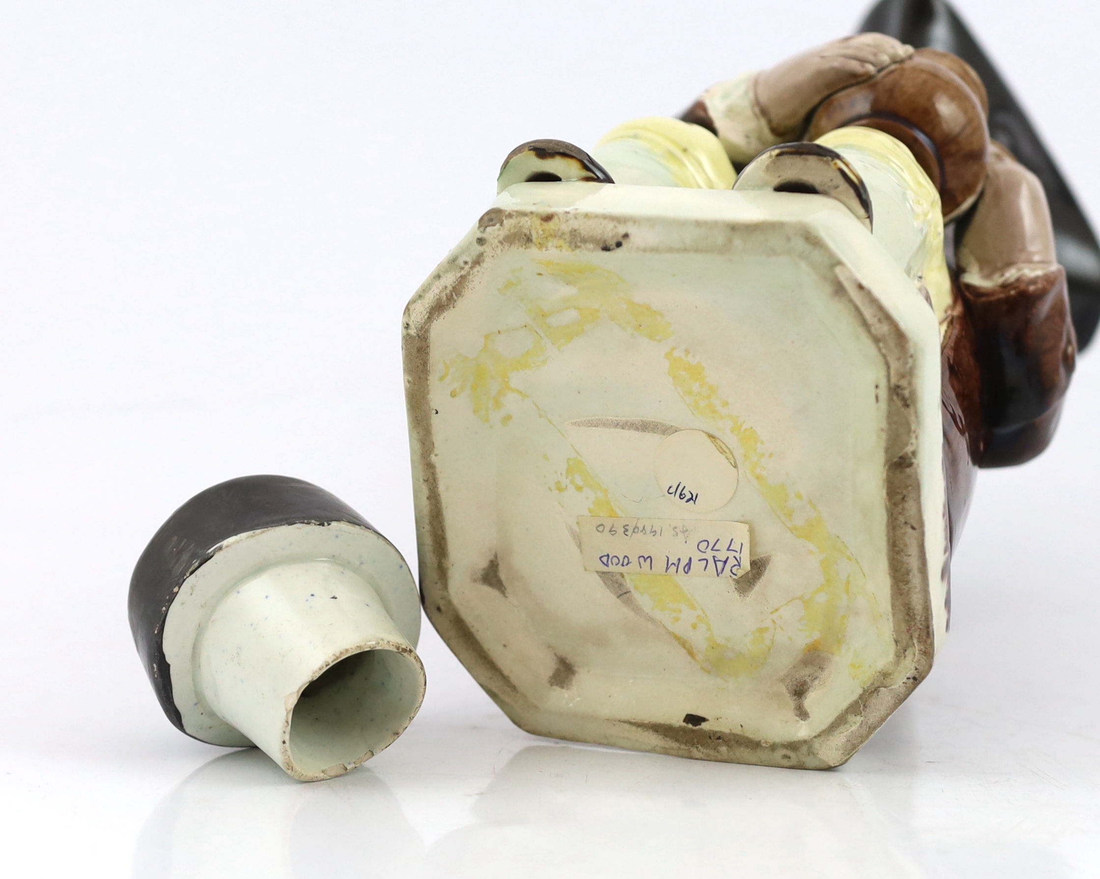 A Ralph Wood type creamware Toby jug of standard type, c.1790, glaze losses and some retouching to the enamels